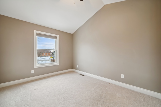 spare room with carpet flooring, ceiling fan, and lofted ceiling