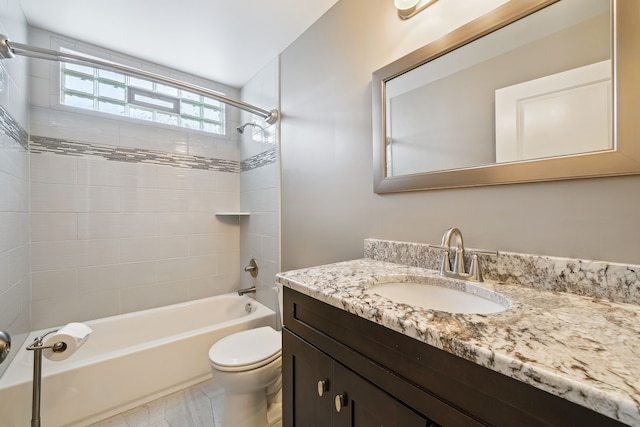 full bathroom with vanity, tiled shower / bath combo, toilet, and tile patterned flooring