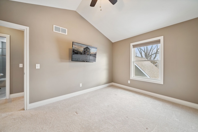 carpeted spare room featuring ceiling fan and lofted ceiling