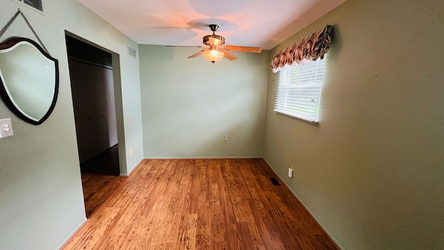 spare room featuring light hardwood / wood-style flooring and ceiling fan