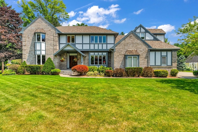 tudor-style house featuring a front lawn