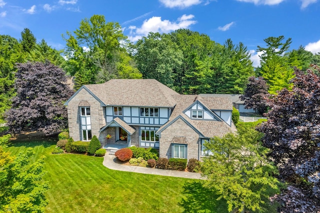 tudor home featuring a front lawn