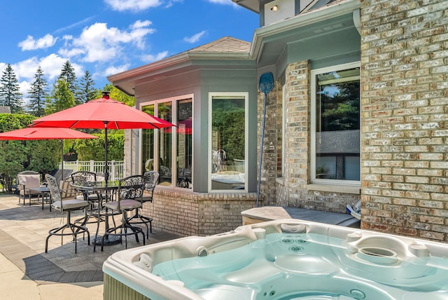 view of patio / terrace with a hot tub