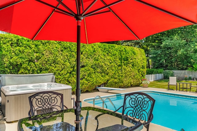 view of swimming pool with a patio and a hot tub