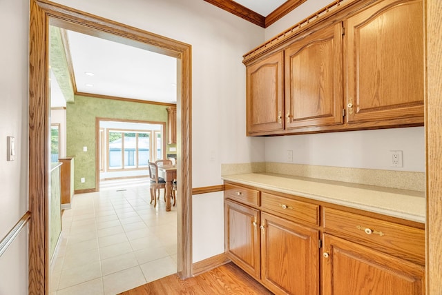 kitchen with light tile patterned flooring and ornamental molding