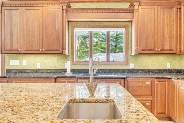 kitchen with light stone counters and sink