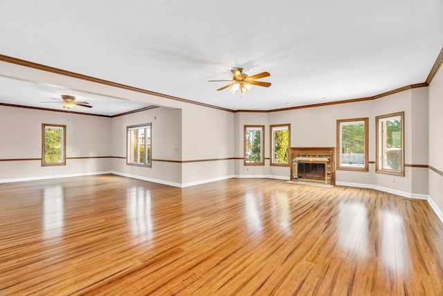 unfurnished living room with ceiling fan, crown molding, and light hardwood / wood-style flooring