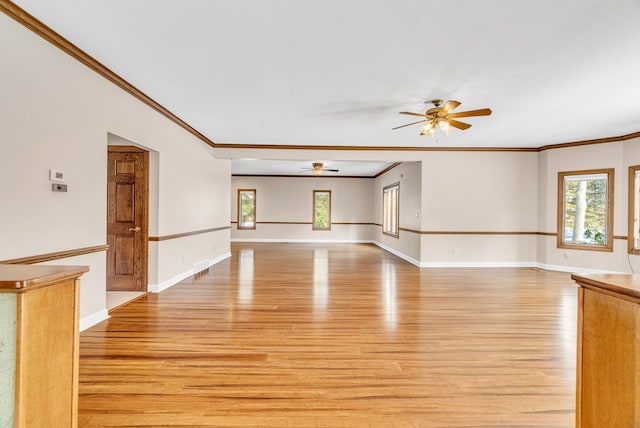 interior space featuring light hardwood / wood-style floors, ceiling fan, and ornamental molding