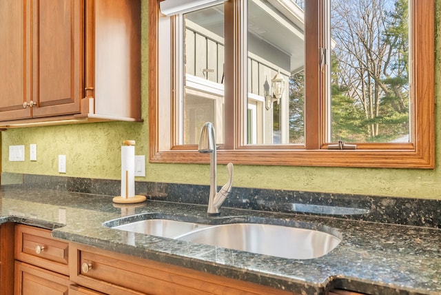 details featuring sink and dark stone counters