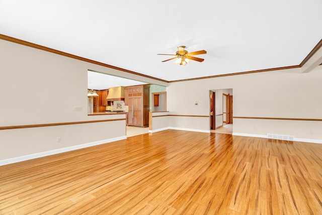 unfurnished living room featuring ceiling fan, ornamental molding, and light hardwood / wood-style floors