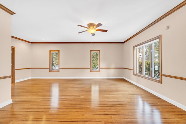 empty room featuring ceiling fan, crown molding, and light hardwood / wood-style flooring