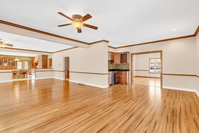 unfurnished living room with ornamental molding, ceiling fan, and light hardwood / wood-style floors