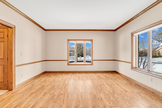 unfurnished room featuring ornamental molding and light wood-type flooring