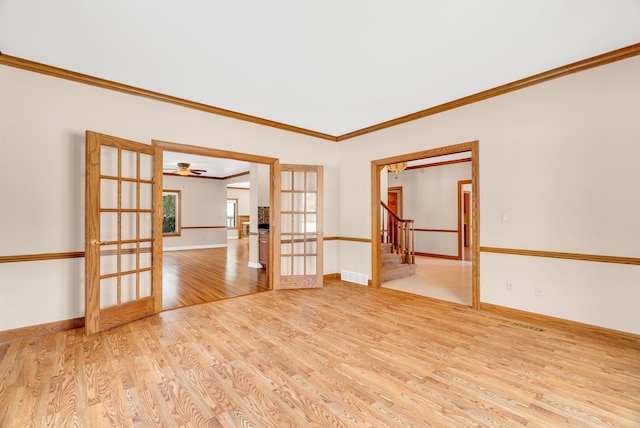 unfurnished room featuring french doors, light wood-type flooring, ceiling fan, and ornamental molding