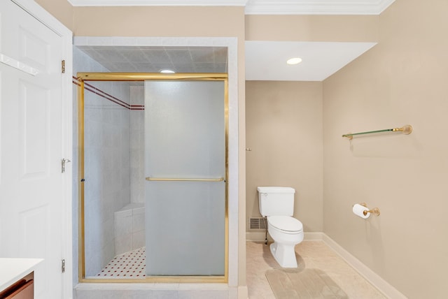 bathroom with tile patterned flooring, toilet, vanity, ornamental molding, and a shower with door