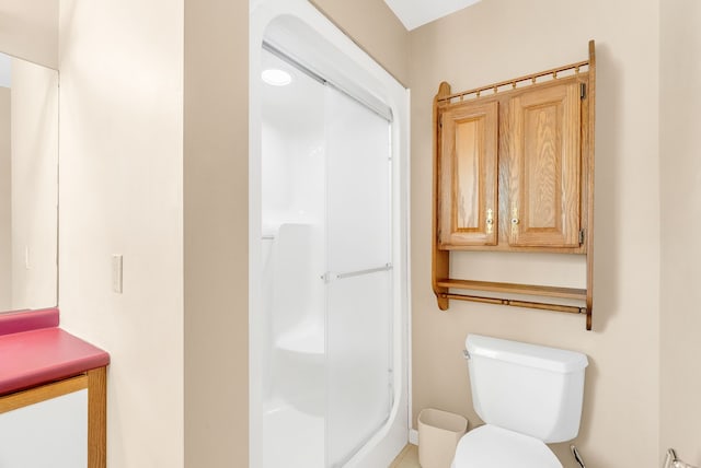 bathroom featuring walk in shower and toilet