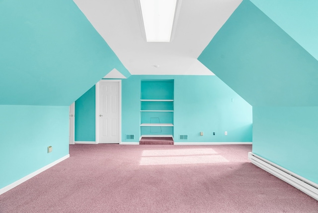 bonus room with baseboard heating, built in features, carpet, and vaulted ceiling with skylight