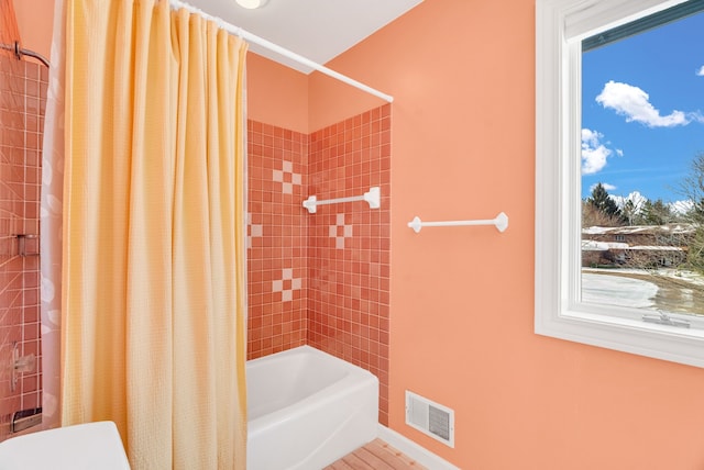 bathroom featuring shower / bathtub combination with curtain