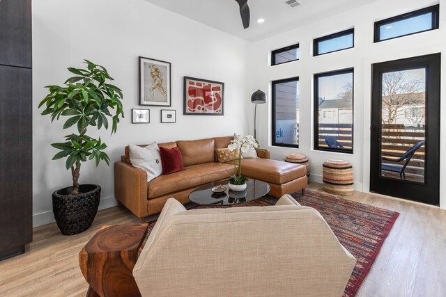 living room featuring ceiling fan and light wood-type flooring