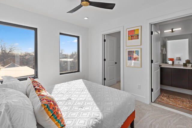 carpeted bedroom featuring ensuite bathroom and ceiling fan