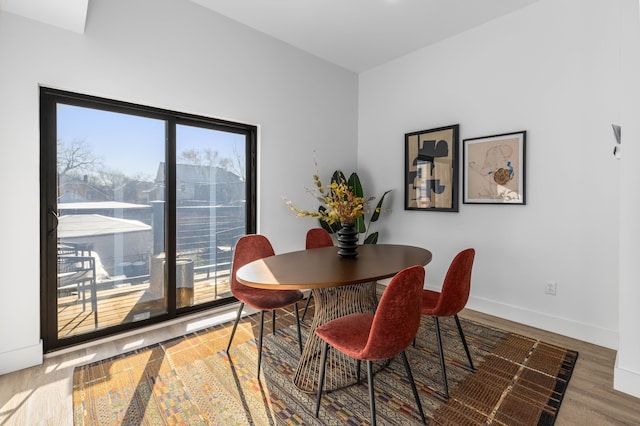 dining room featuring plenty of natural light and hardwood / wood-style flooring