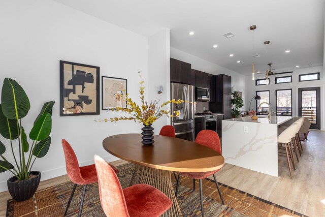 dining room featuring light hardwood / wood-style flooring and ceiling fan