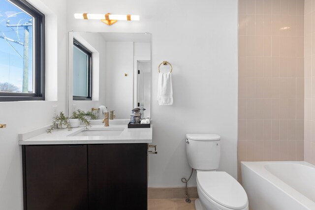 full bathroom with tile patterned flooring, vanity, toilet, and tiled shower / bath combo