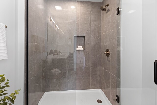 bathroom featuring a shower with shower door