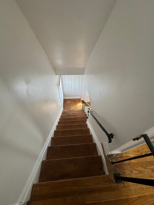 stairs featuring wood-type flooring