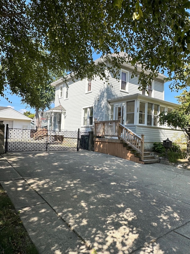 view of front of house featuring a sunroom