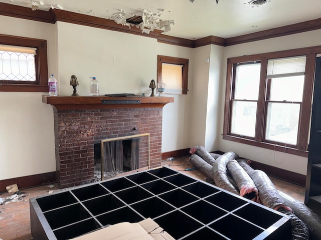 living room featuring a fireplace, ornamental molding, and a healthy amount of sunlight