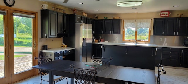 kitchen with pendant lighting and stainless steel refrigerator with ice dispenser