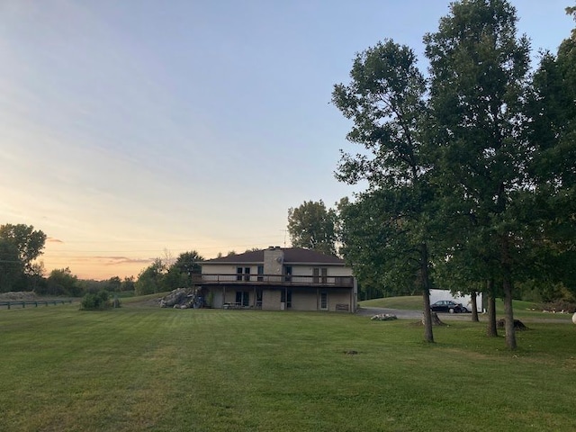 view of front facade featuring a deck and a lawn