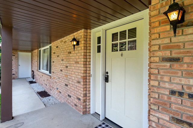 view of exterior entry with a porch