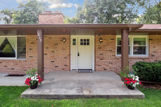 view of exterior entry with covered porch