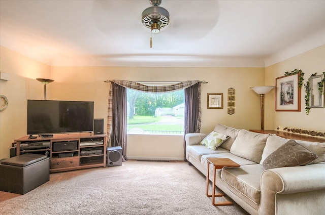 carpeted living room with ceiling fan