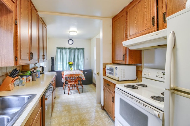 kitchen featuring white appliances and sink