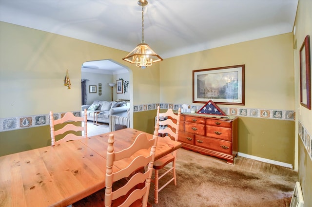 carpeted dining space with a baseboard radiator