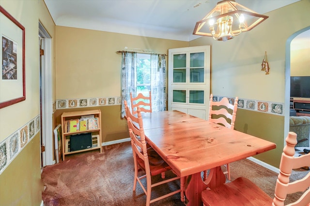 dining room featuring carpet flooring and an inviting chandelier