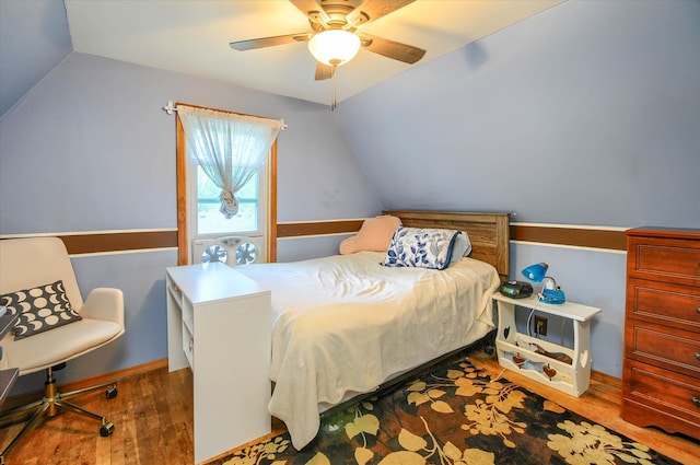 bedroom featuring hardwood / wood-style flooring, vaulted ceiling, and ceiling fan