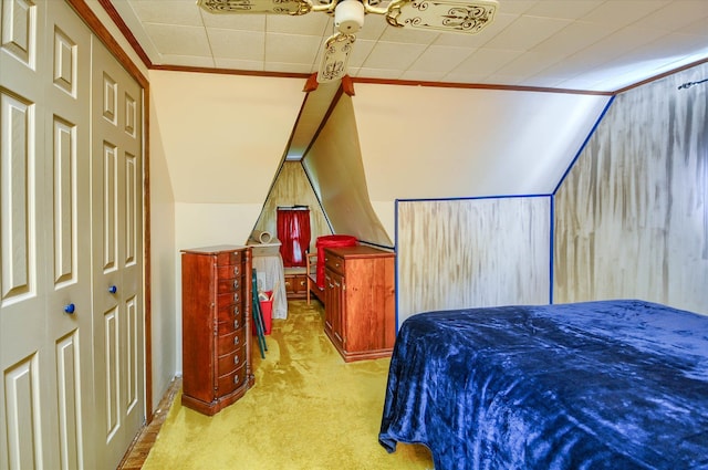 carpeted bedroom with vaulted ceiling and ornamental molding