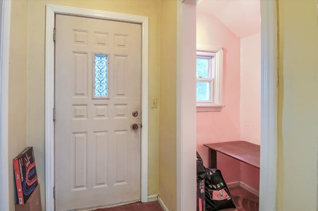 foyer entrance featuring vaulted ceiling