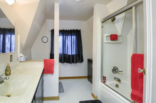 bathroom with combined bath / shower with glass door, vanity, and vaulted ceiling