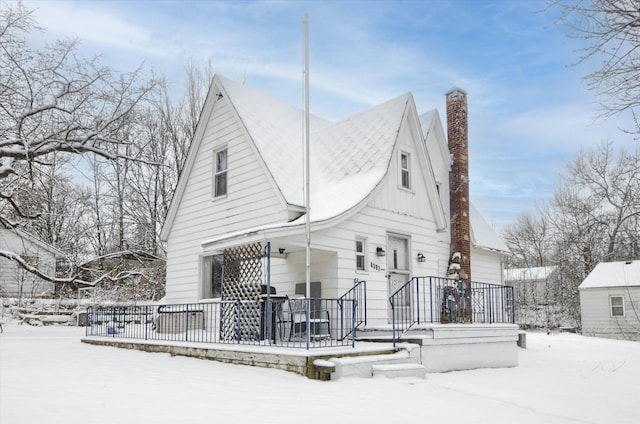 view of snow covered rear of property