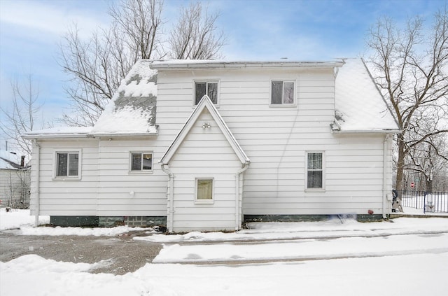 view of snow covered rear of property