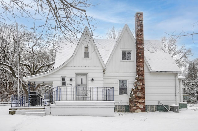 view of snow covered back of property