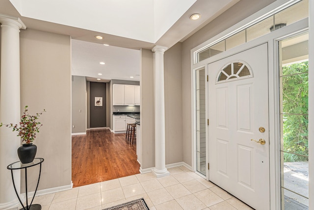 tiled foyer with ornate columns