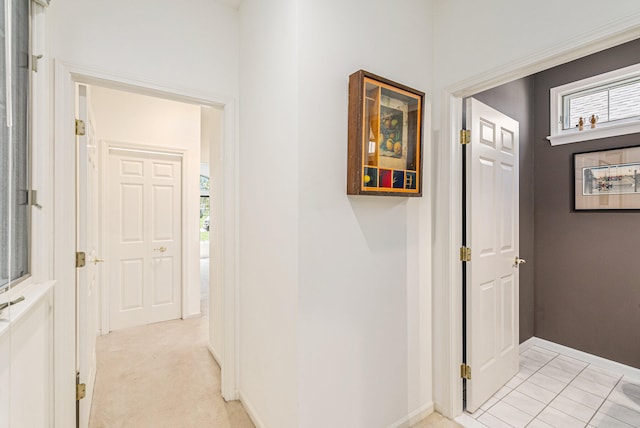 hallway featuring light colored carpet