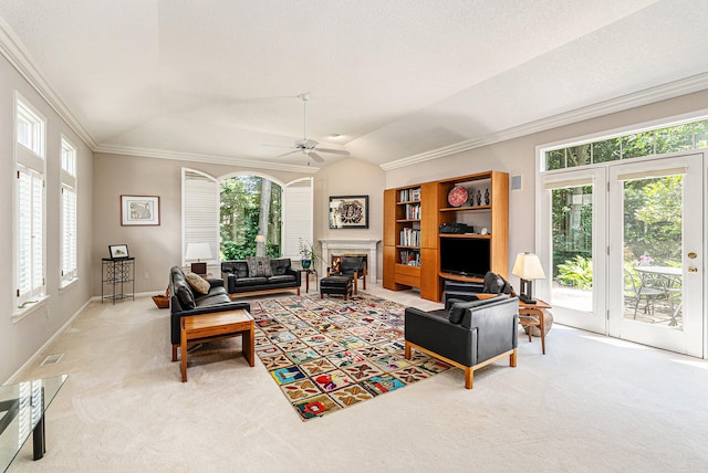 living room featuring crown molding, carpet flooring, lofted ceiling, and ceiling fan