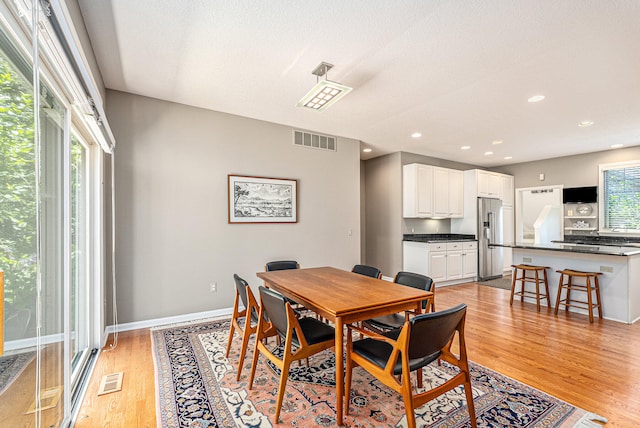 dining room featuring light hardwood / wood-style floors and plenty of natural light